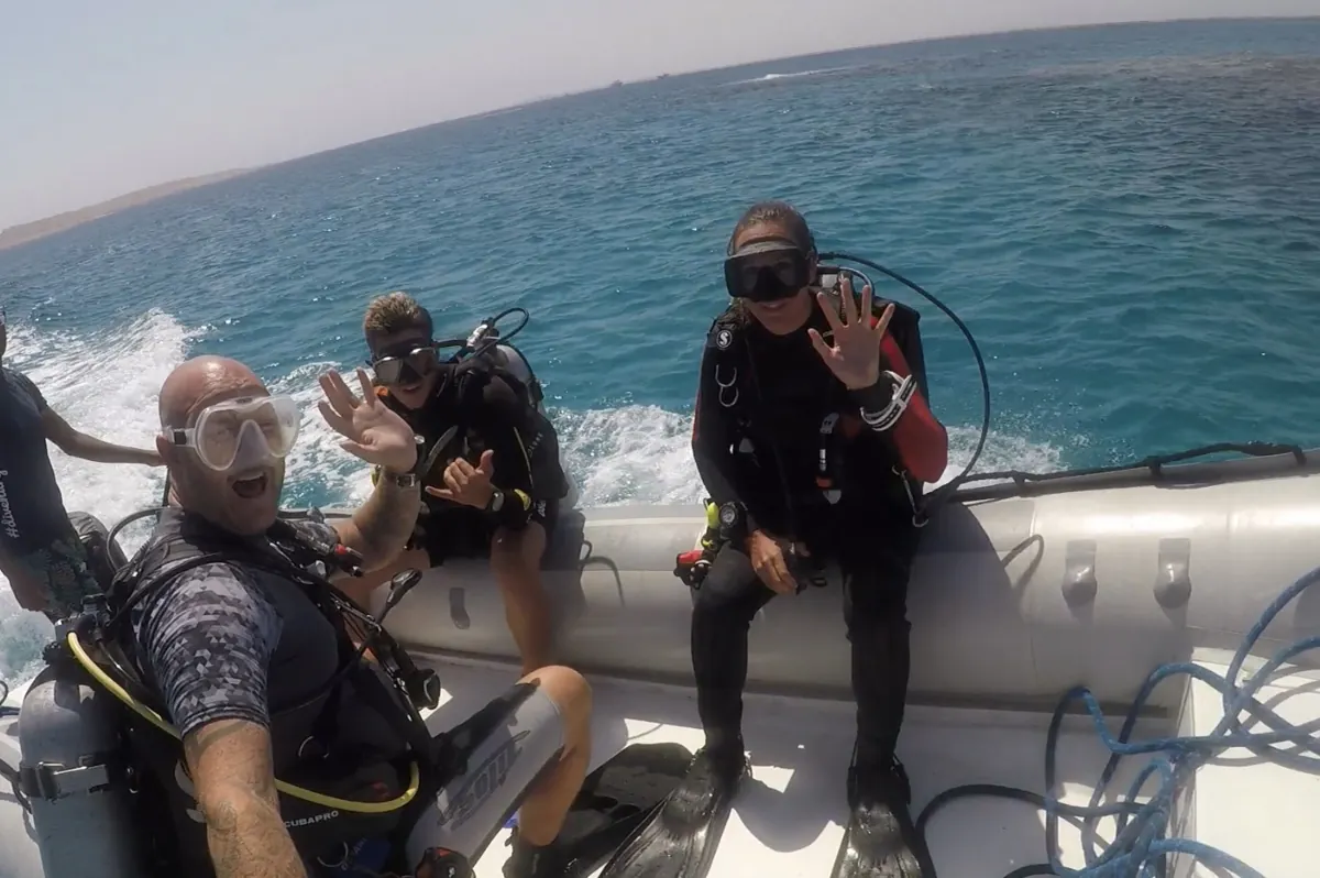 Divers wearing scuba equipment on a small boat in the Red Sea