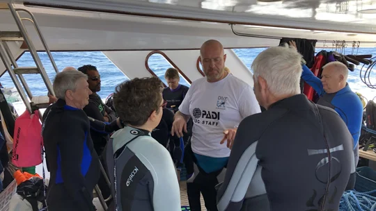 Dive UK instructor briefing a small group before diving in Hurghada