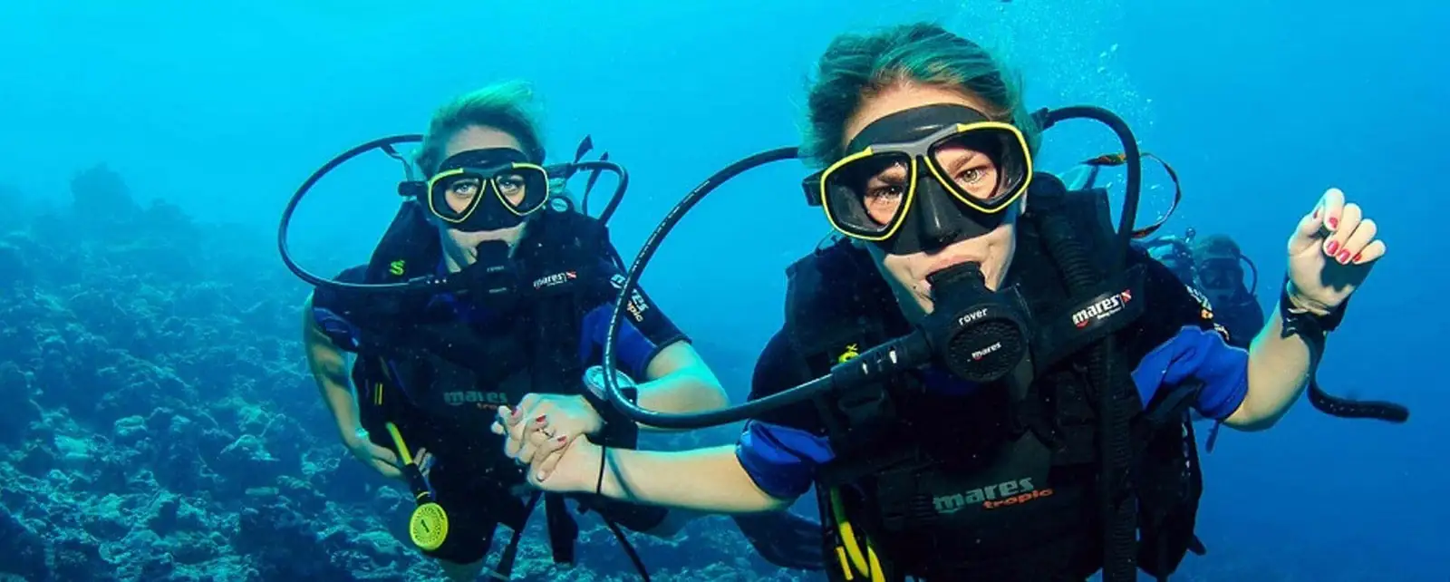Two scuba divers swimming together underwater