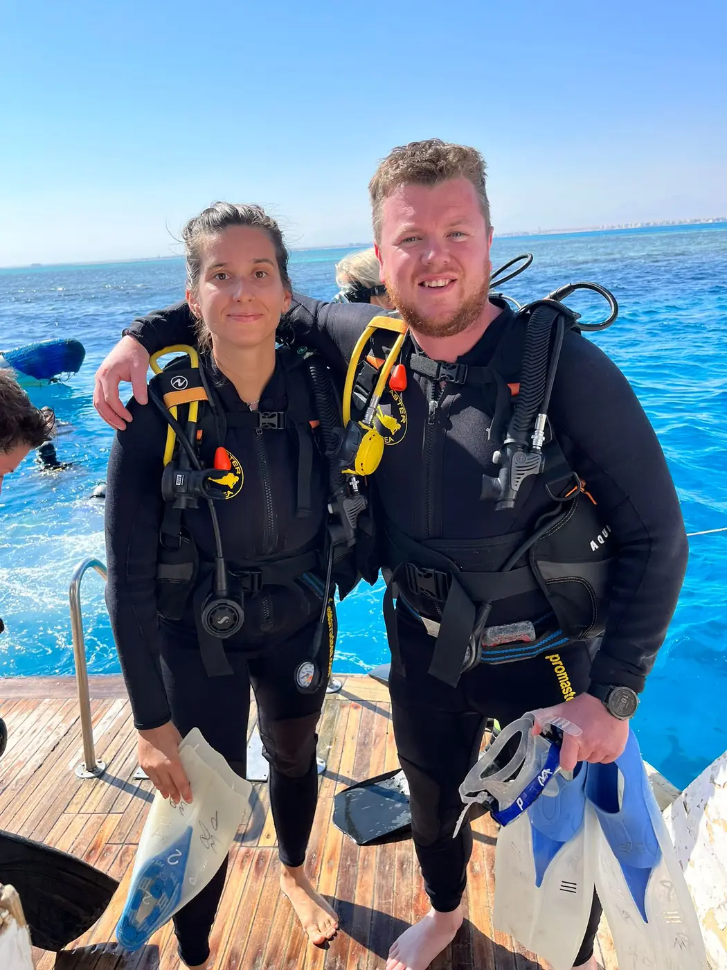 Two divers wearing scuba equipment on a boat in Hurghada