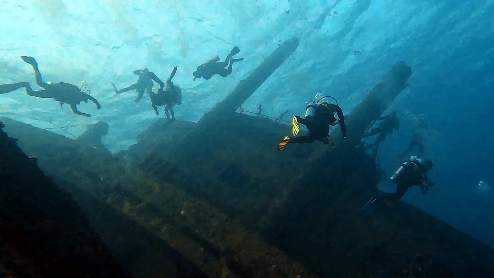 Divers exploring above a shipwreck during wreck diving in Hurghada