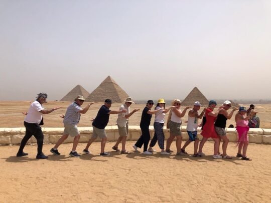 Guests posing together at the pyramid viewpoint on their Cairo trip from Hurghada
