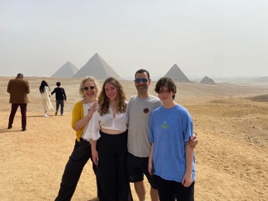 Four guests at the Giza pyramids on a Cairo trip from Hurghada