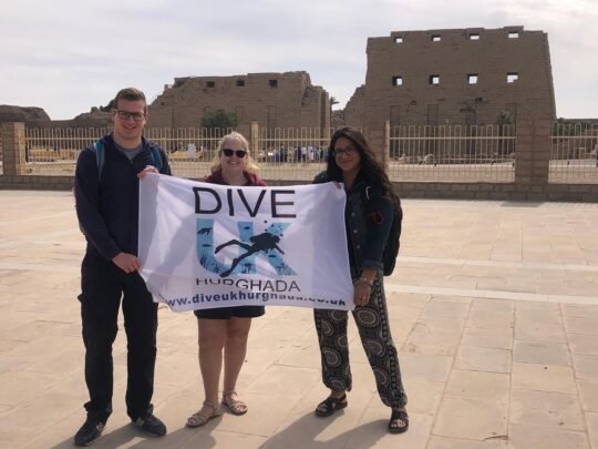 Guests with the Dive UK flag at Karnak Temple on a Luxor trip from Hurghada