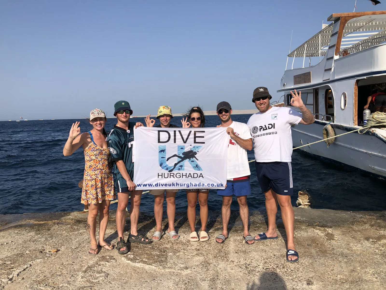 Guests beside a dive boat on their trip to Hurghada with Dive UK