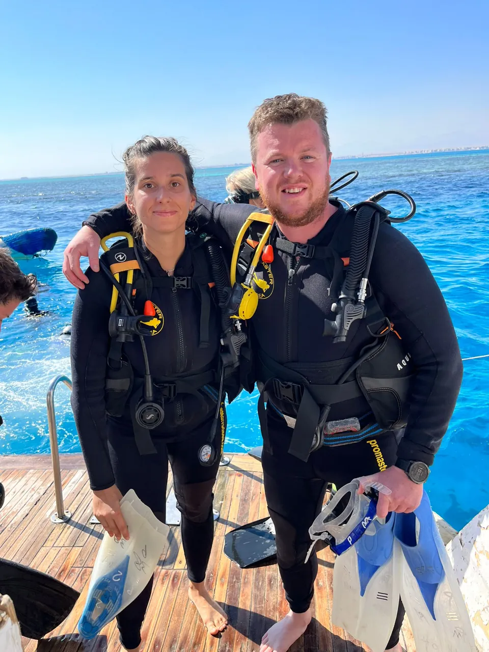 Two scuba divers standing together in their diving equipment on a boat in Hurghada