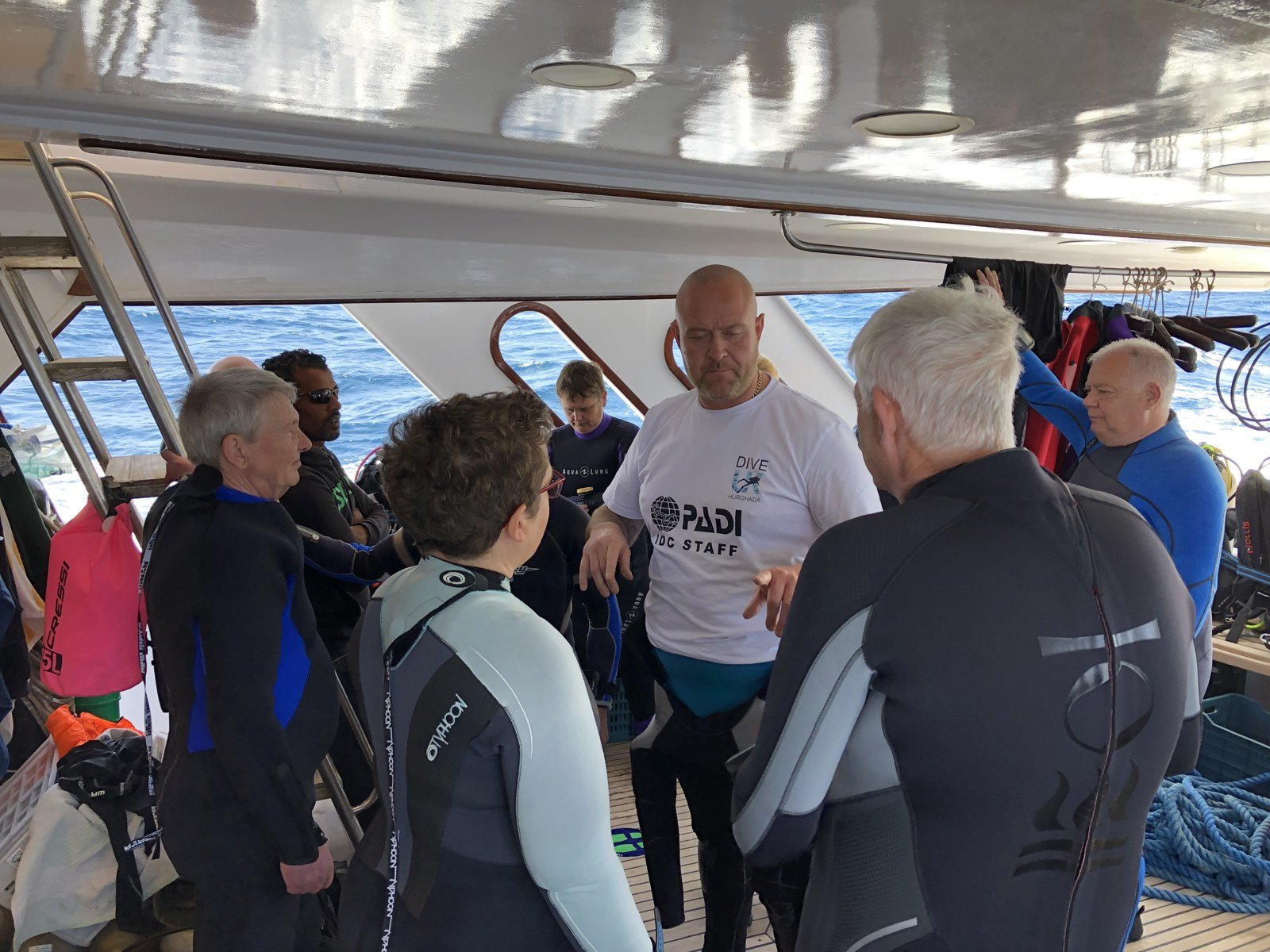 Dive UK instructor briefing a small group before diving in Hurghada