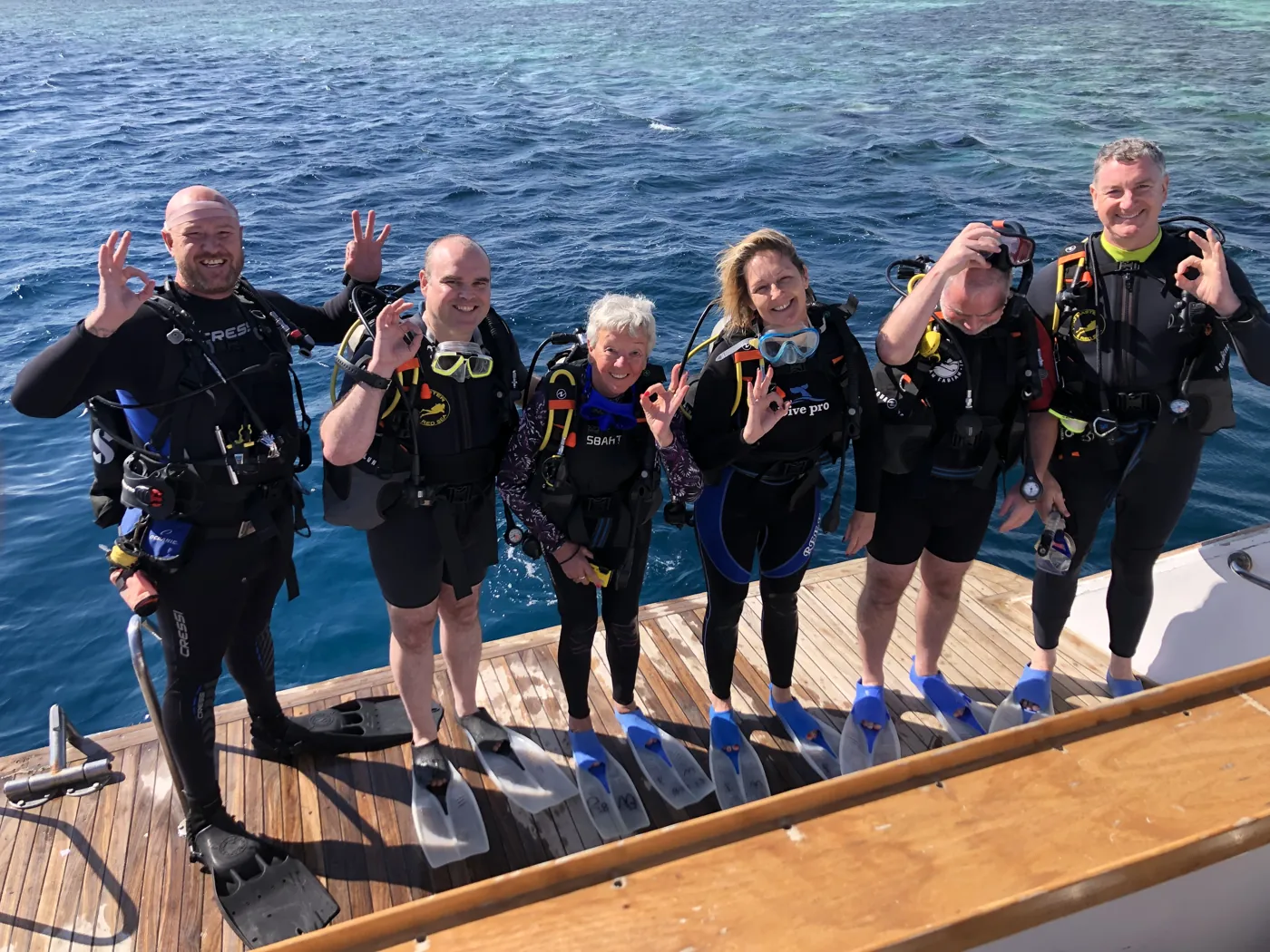 Divers in scuba equipment on a boat platform in Hurghada