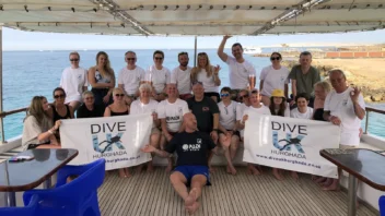 A group on the boat holding Dive UK Hurghada banners