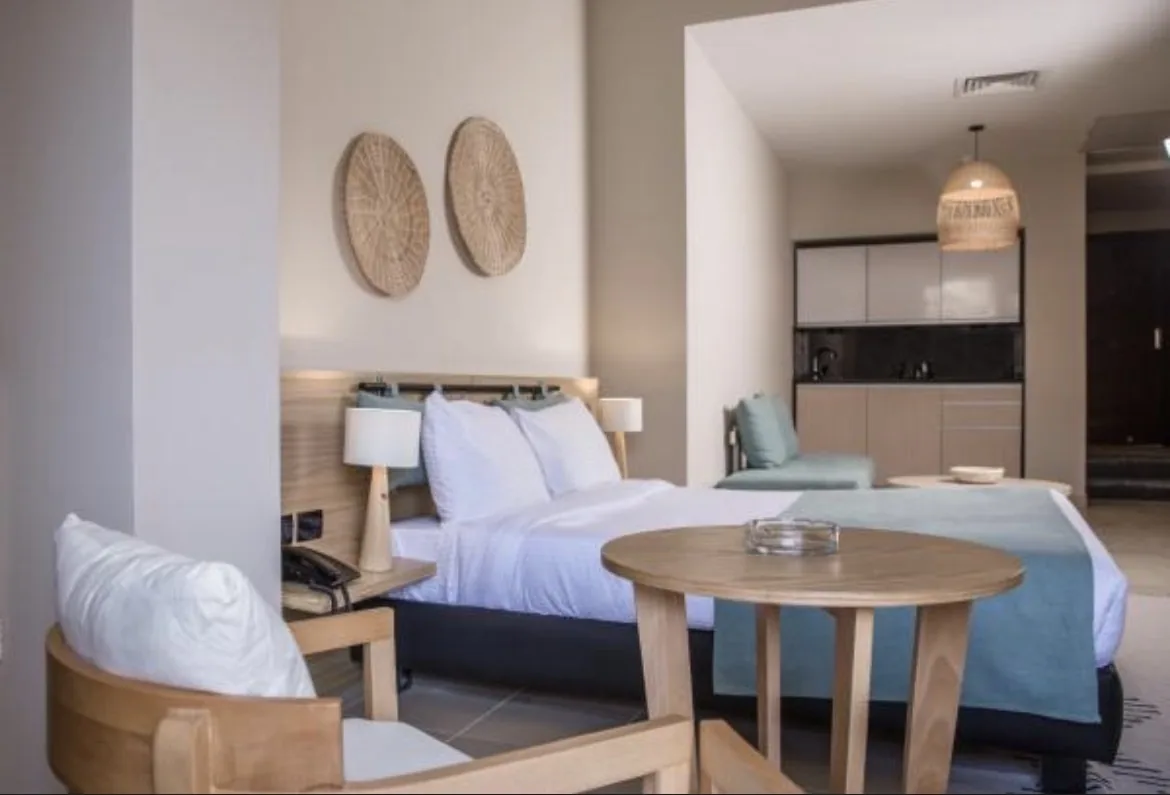 Studio accommodation with a double bed, seating area and kitchenette