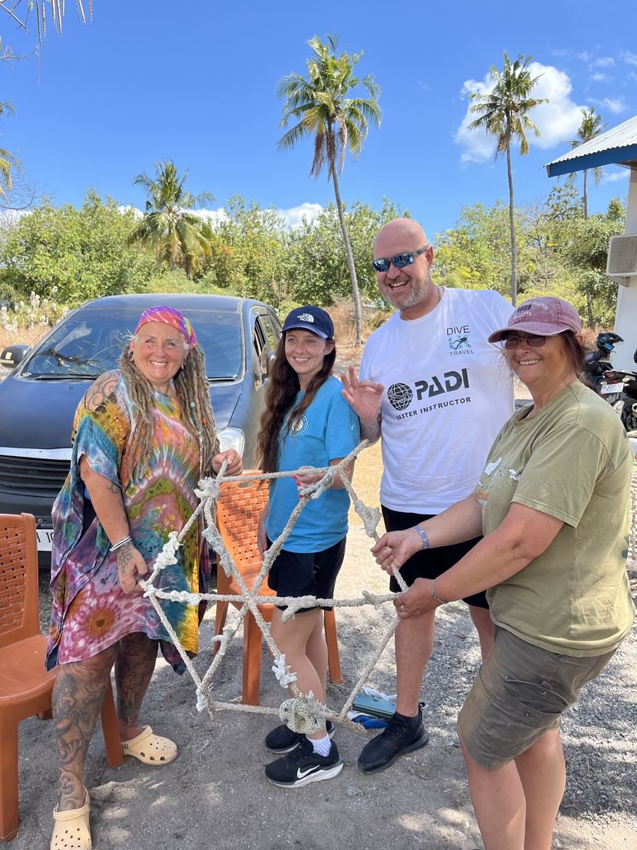Dive UK team and fellow divers holding a prepared reef star in Indonesia