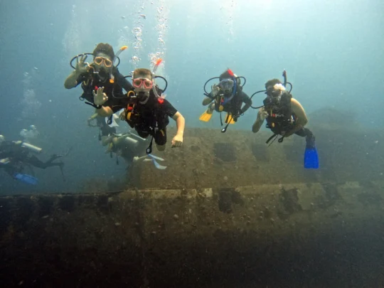 Young divers exploring an underwater structure in Hurghada during junior diving training